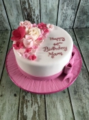 birthday cake with  pink sugar roses and bow