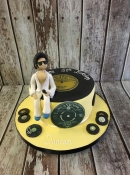 Elvis sitting on a record