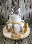 gold and silver bow birthday cake