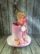 chocolate drip cake with sweets and merangues birthday cake