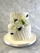 2 tier buttercream wedding cake with silk flowers