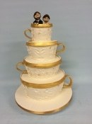 couple in tea cups wedding cake