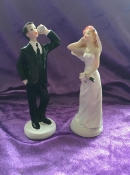 wedding cake topper bride and groom on their phones