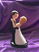 bride and groom hugging cake topper