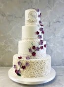 Delicate-blossoms-with-lace-ribbons-and-ruffles-wedding-cake-