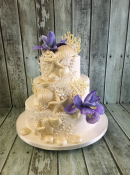 seaside wedding cake with chocolate shells and sugar iris flower
