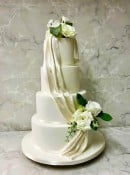 sugar Satin Drape wedding cake with Silk flowers 