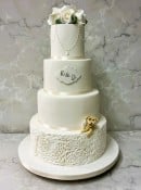 Sugar embossed Rosettes wedding cake with pearls  and sugar peeping Dog 