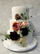 Iced-wedding-cake-with-gold-leaf-and-silk-flowers-