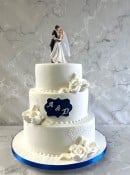 Romantic-wedding-cake-with-hand-piped-lace-and-sugar-roses-