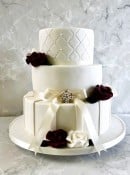 Trellis-wedding-cake-with-satin-riibbon-and-vintage-brooch-and-sugar-flowers