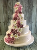 cascading roses and edelweiss flowers wedding cake