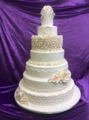 extra large wedding cake with lace and roses