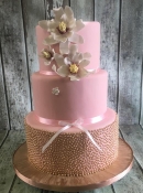 pink and gold wedding cake with fantasy flowers