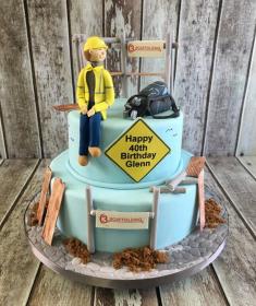 construction man building birthday cake