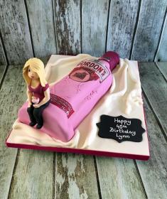 pink gin birthday cake with sugar figure