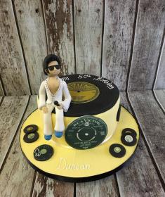 Elvis sitting on a record