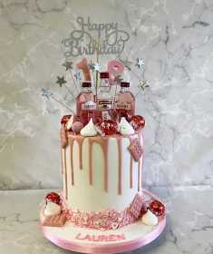 Drip style birthday cake with mini pink gin bottles 