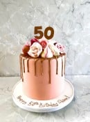 Drip style birthday cake with sugar flowers and meringues 