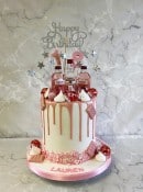 Drip style birthday cake with mini pink gin bottles 