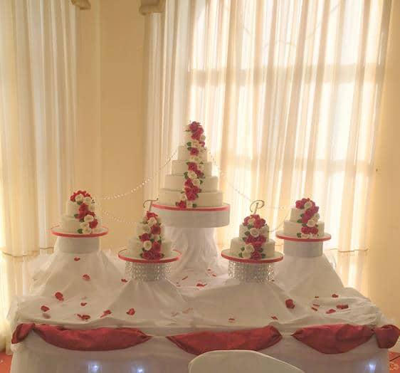 Extra large wedding cake before matching smaller cakes all the cascading Sugar Roses