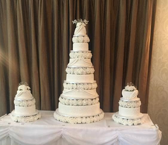 extra large wedding cake and two side cakes all matching separated with sugar flowers and ice in detail to finish it off in colours of your choice