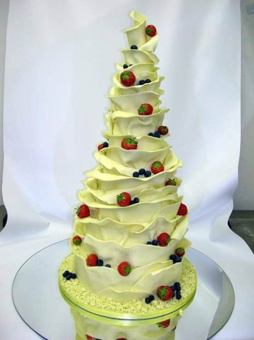 Chocolate wrap wedding cake decorated with fresh cherries