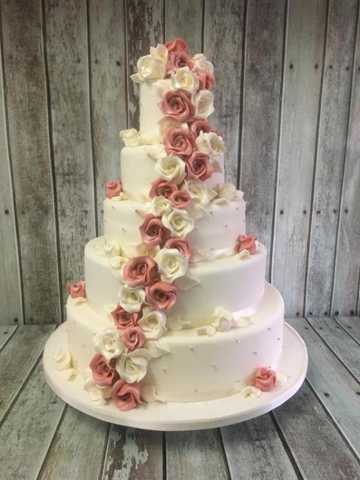 Extra large wedding cake with cascading sugar flowers,, Roses and Edelweiss in a vintage pink and white