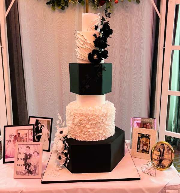 Extra large wedding cake with hexagonal tiers and ruffles