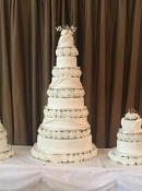 extra large wedding cake and two side cakes all matching separated with sugar flowers and ice in detail to finish it off in colours of your choice