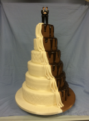 Extra large split wedding cake design half chocolate and half icing separated with a cascading swag of icing