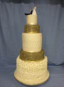 Extra large wedding cake with gold sequence at sugar ruffles and ceramic cake topper