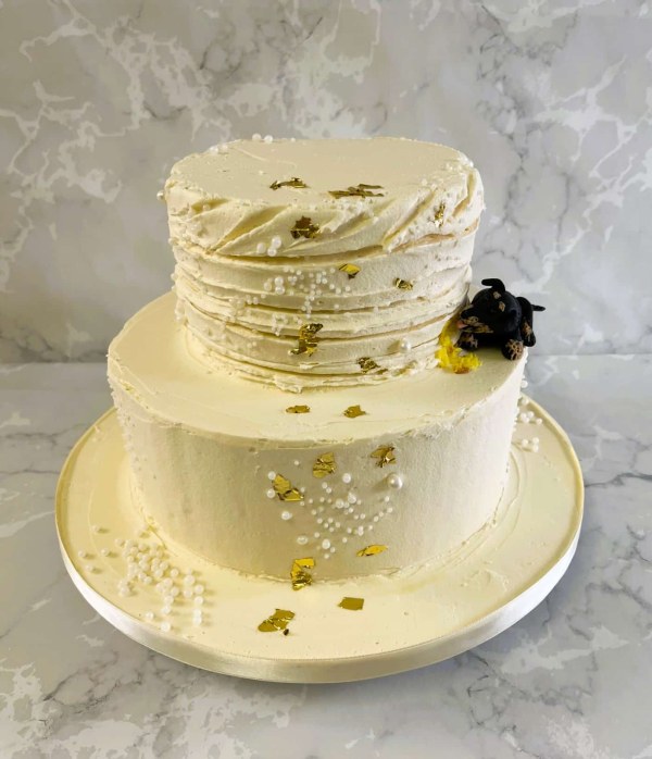 2-tier-buttercream-wedding-cake-with-dog-eating-into-the-cake-