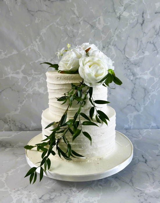 2-tier-buttercream-wedding-cake-with-silk-flowers-sand-greenery-