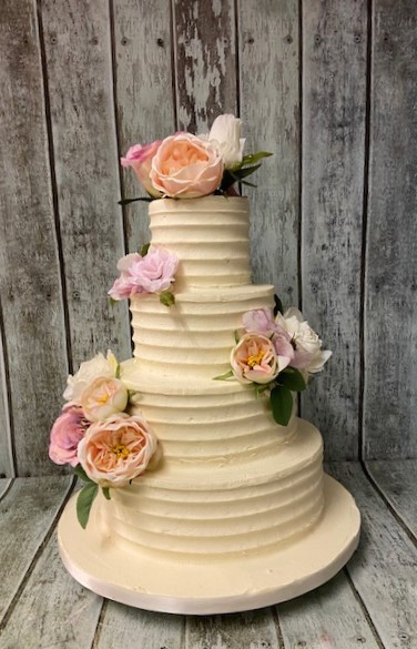 4-tier-combed-buttercream-wedding-cake-with-silk-flowers-