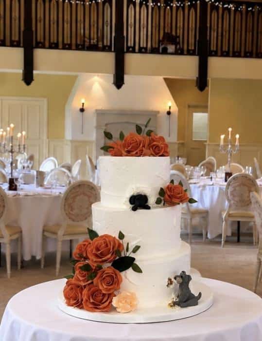 Buttercream-wedding-cake-with-rust-colour-Roses-and-Dogs-eating-into-the-cake-at-Brooklodge-Macreddin-village-Wicklow