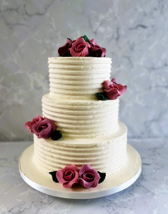 Combed buttercream wedding cake with handmade sugar roses
