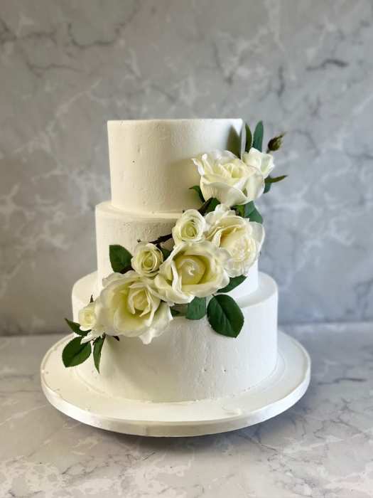3 tier frosting wedding  cake with cascading silk flowers