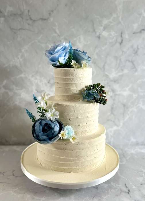 Stunning Blue flowers on a buttercream wedding cake