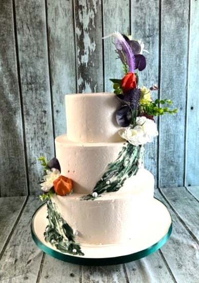 buttercream-with-green-applique-and-wiild-silk-flowers-