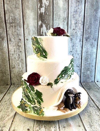 green-appique-buttercream-with-sugar-roses-and-sugar-dogs-peeking-out-