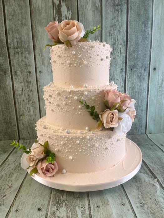Pink buttercream pearl wedding cake