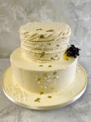 2-tier-buttercream-wedding-cake-with-dog-eating-into-the-cake-