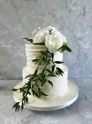2-tier-buttercream-wedding-cake-with-silk-flowers-sand-greenery-
