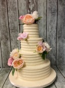 4-tier-combed-buttercream-wedding-cake-with-silk-flowers-