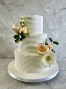 Fine lines buttercream wedding cake with silk flowers 