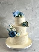 Stunning Blue flowers on a buttercream wedding cake 