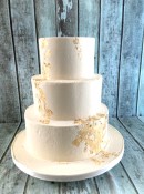 buttercream-wedding-cake-adorned-with-gold-leaf