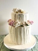 buttercream-wedding-cake-with-tall-bottom-sand-sugar-flowers-