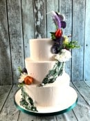 buttercream-with-green-applique-and-wiild-silk-flowers-